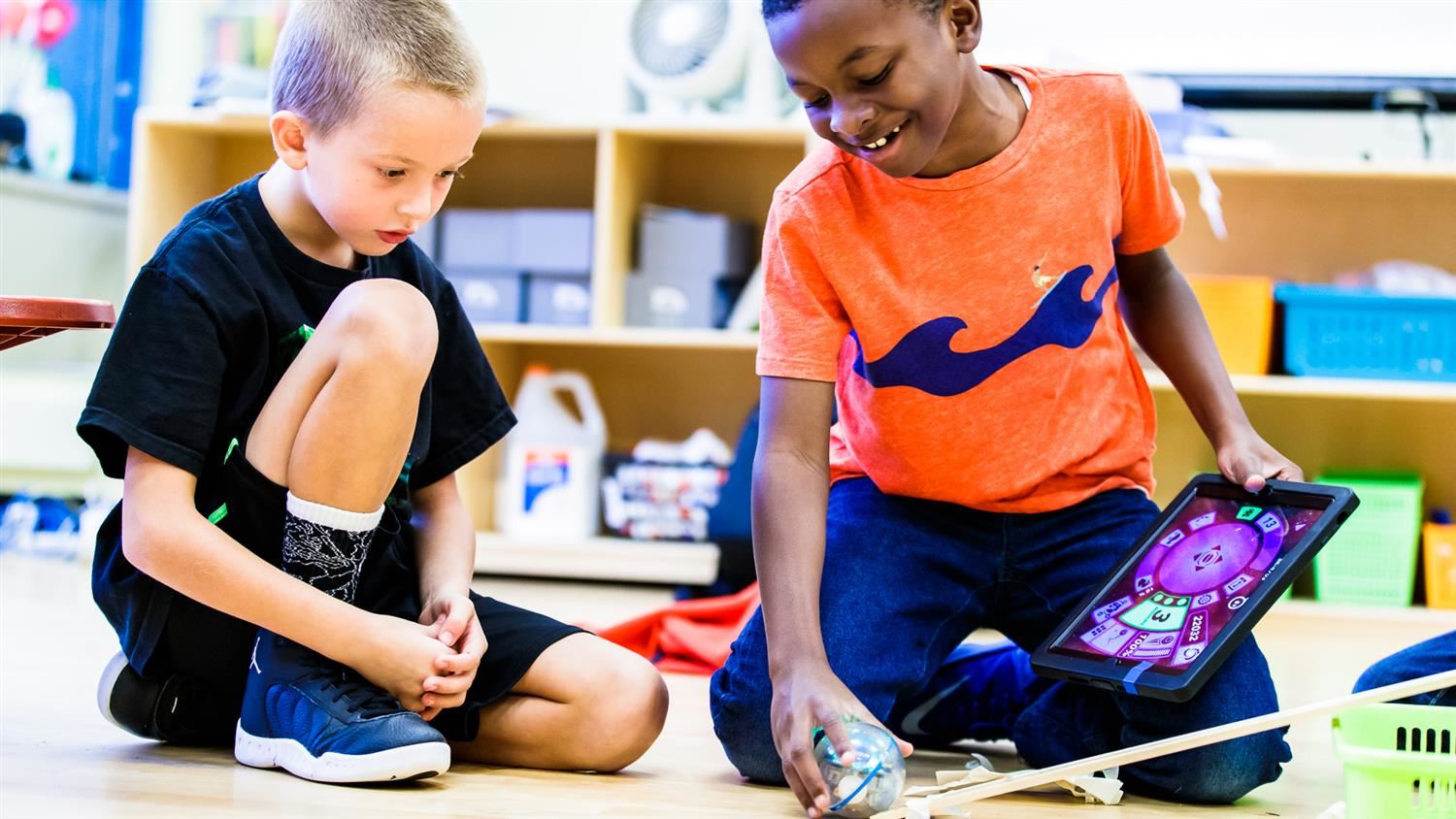 Bugg Elementary students work with a sphero robot. 