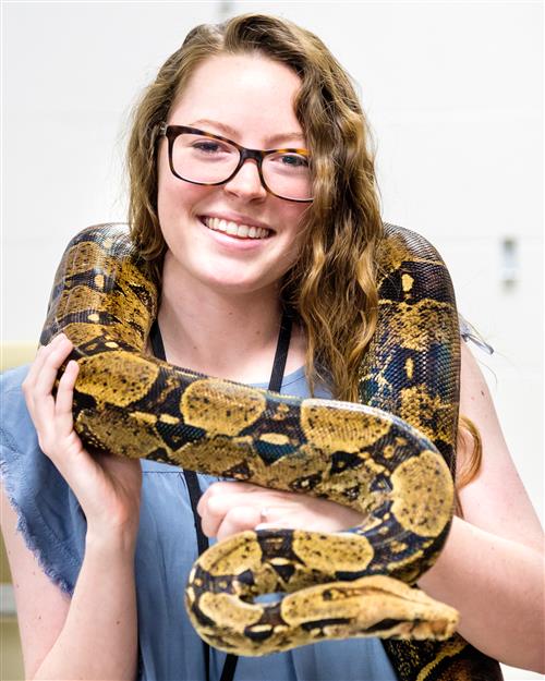 photo of teacher holding a snake 