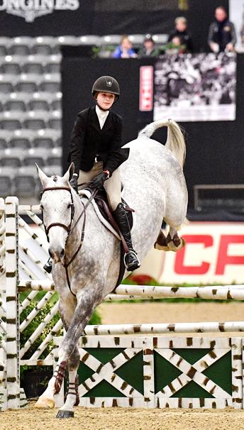 Caroline Weaver jumping in competition. 