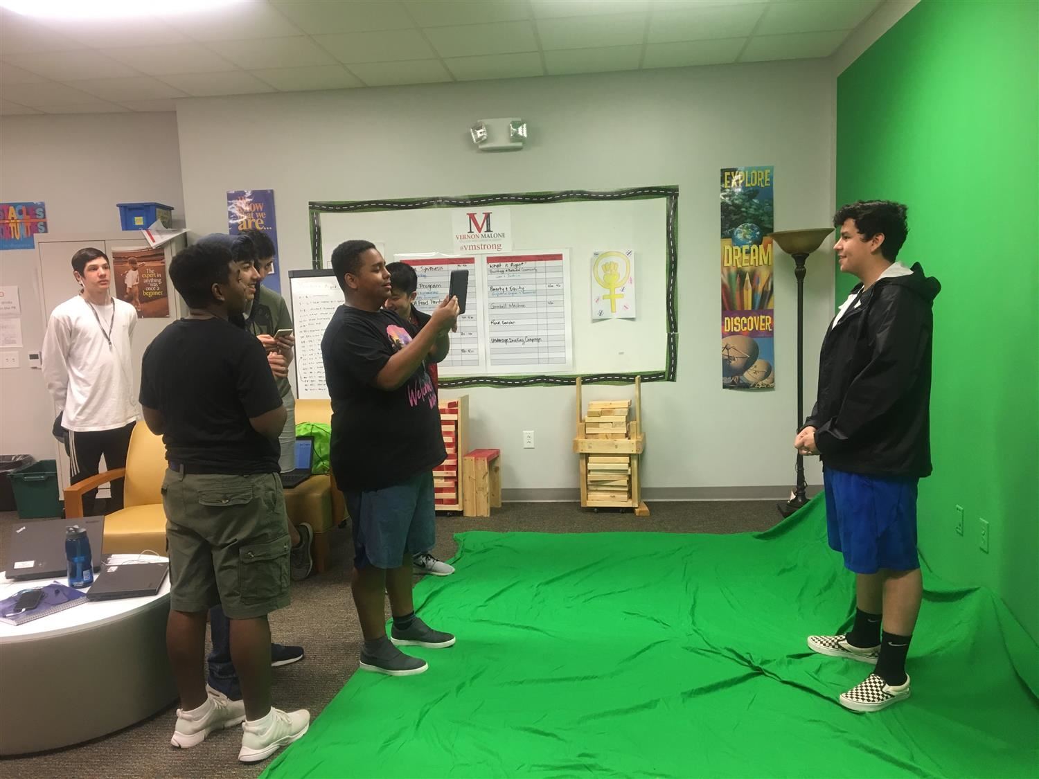 Students filming in front of green sreen. Students filming in front of green sreen.