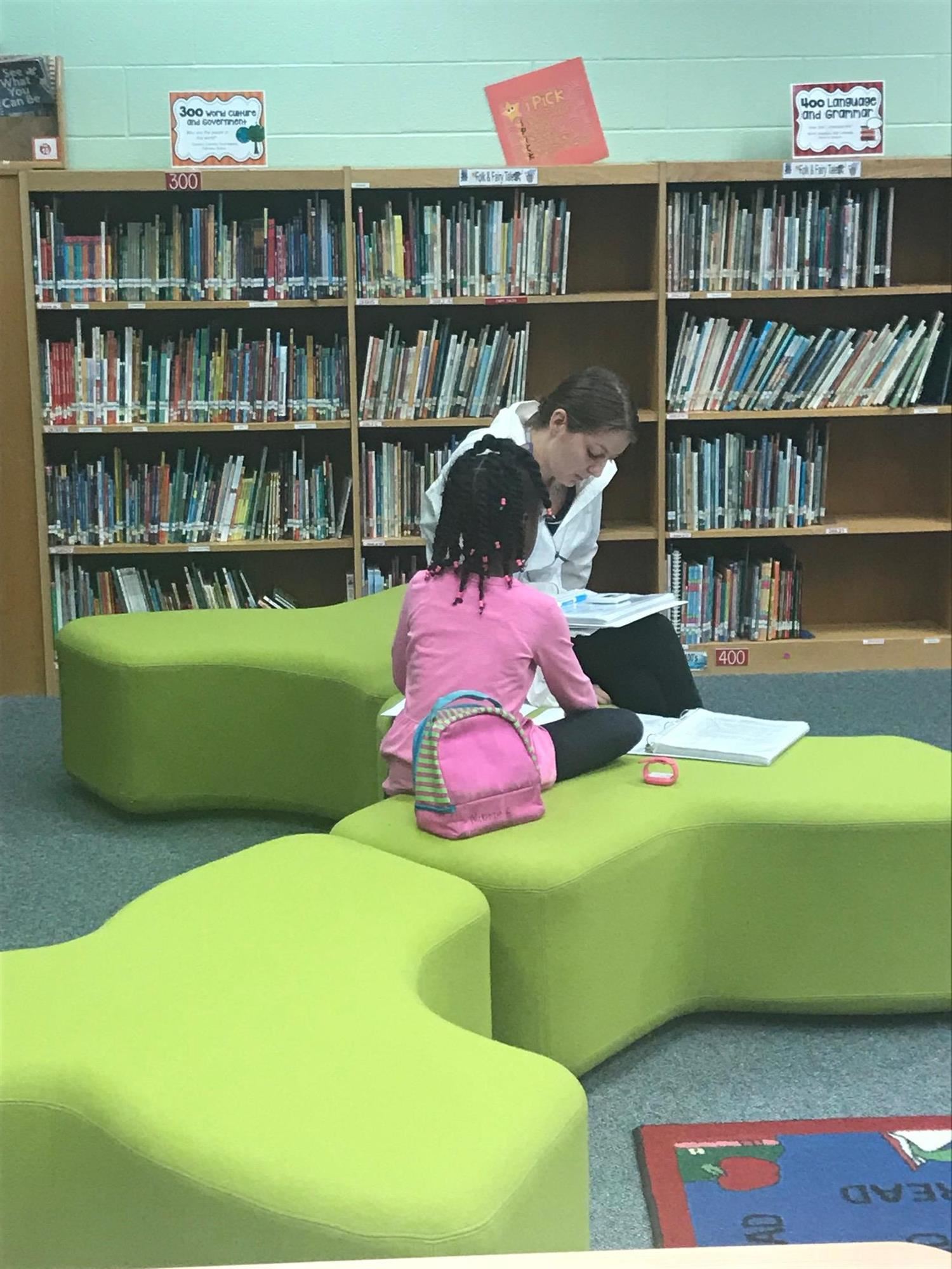 student and teacher reading in the media center student and teacher reading in the media center