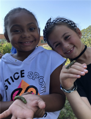 Students holding insects.