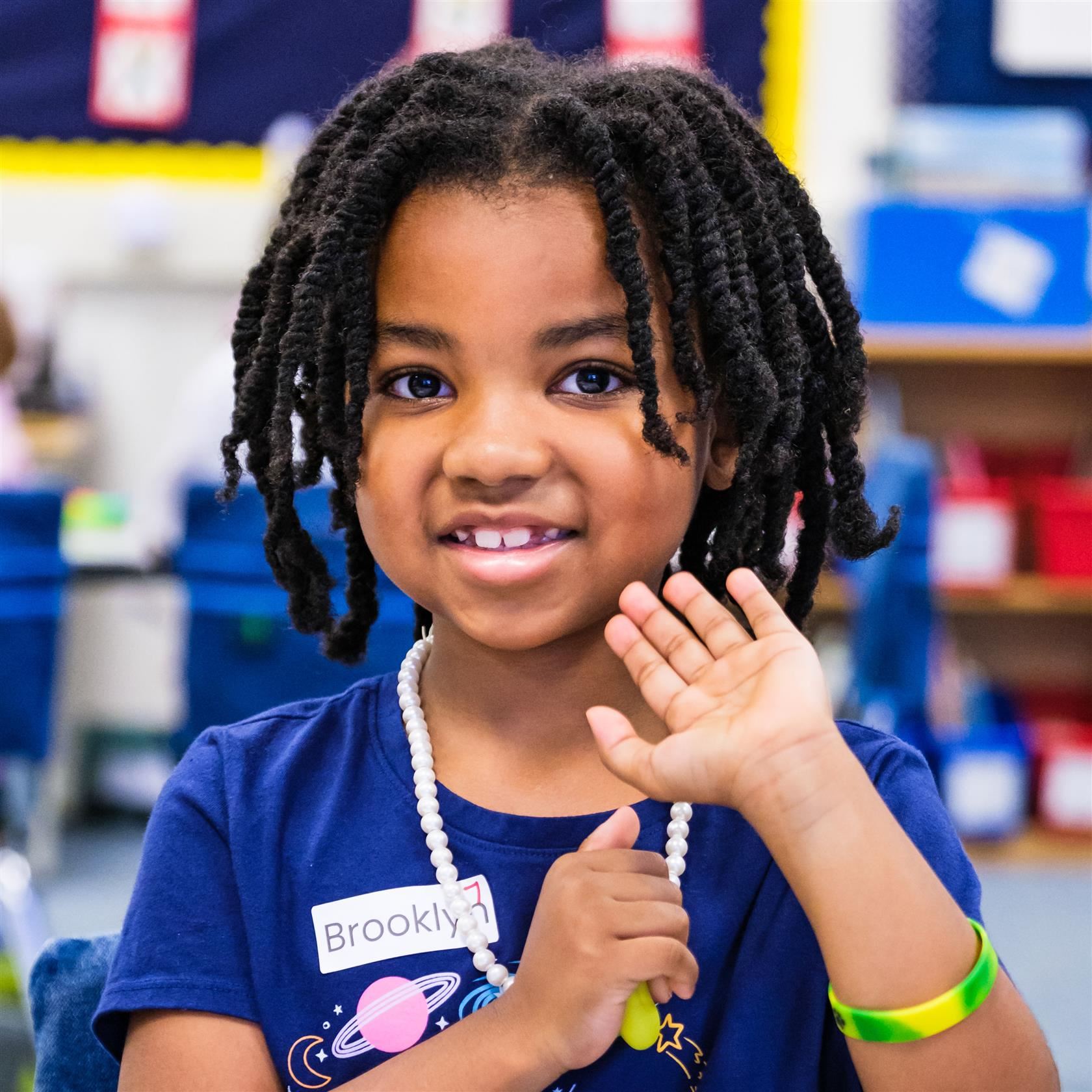 student waving