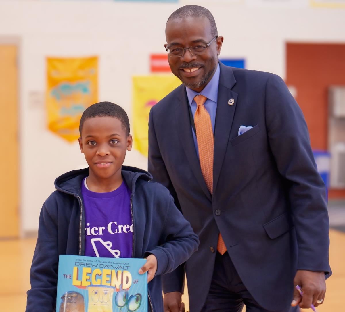 Dr. Taylor smiles for the camera with a Brier Creek student