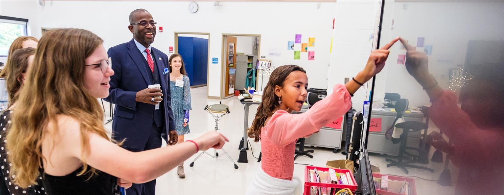 Image of Dr. Taylor with students on smart board