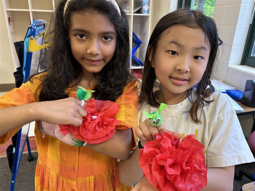 students showing birds they made during clubs