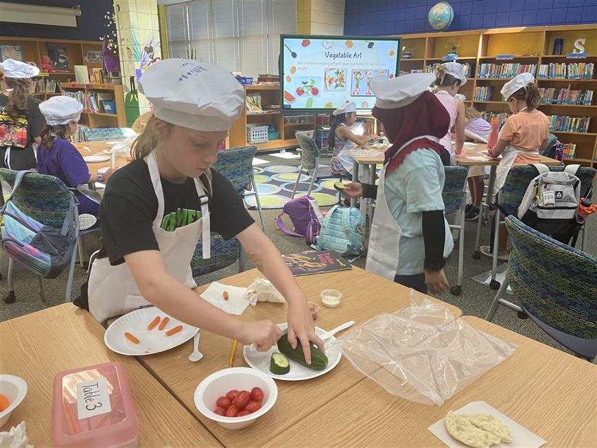 students making vegetable art during cooking club