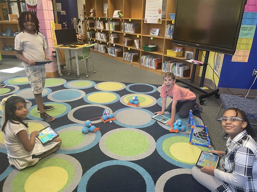students using robots to play soccer